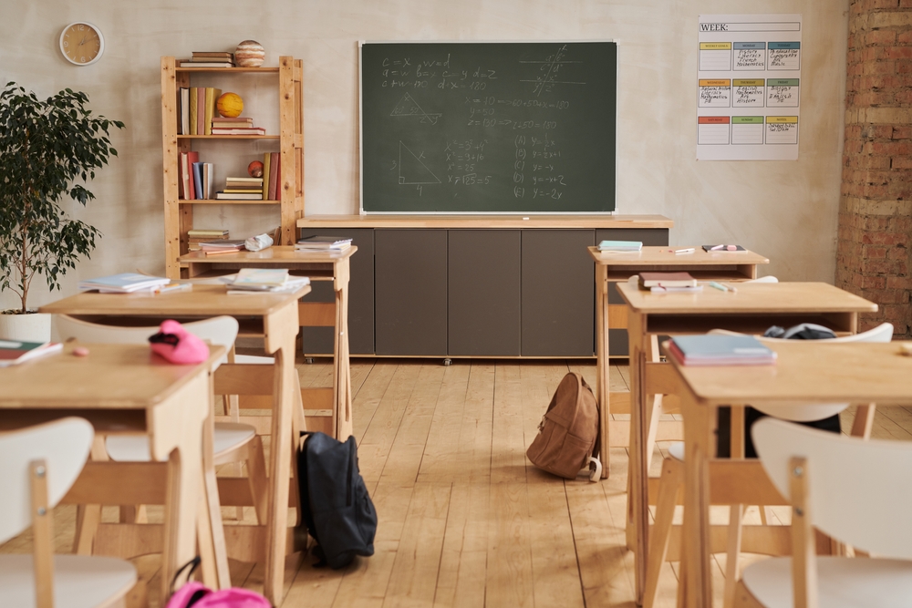 wide,angle,background,image,of,wooden,school,desks,in,row